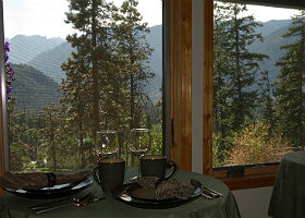 View of dining area showing bistro tables for two with breakfast settings.