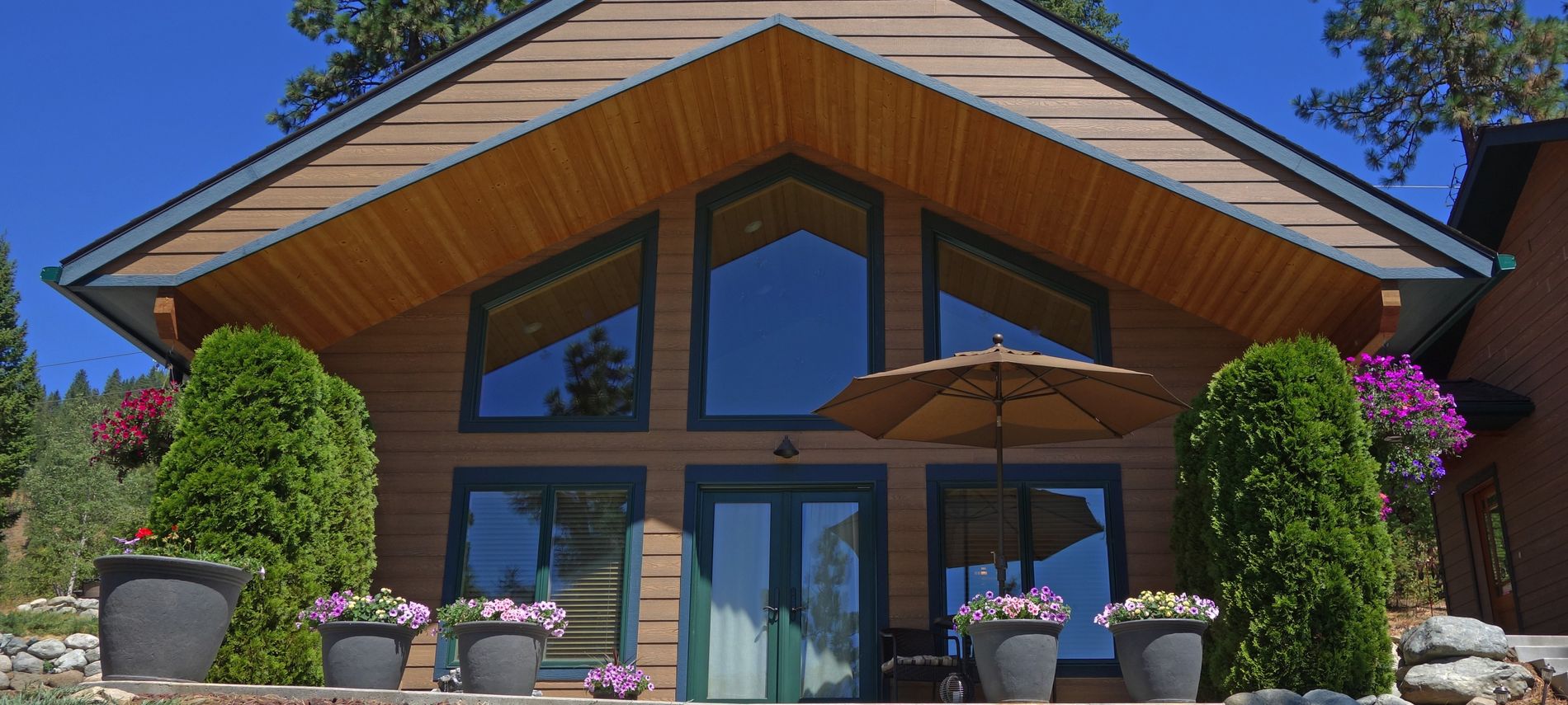 Exterior of the room showing blue skies and pink flowers.