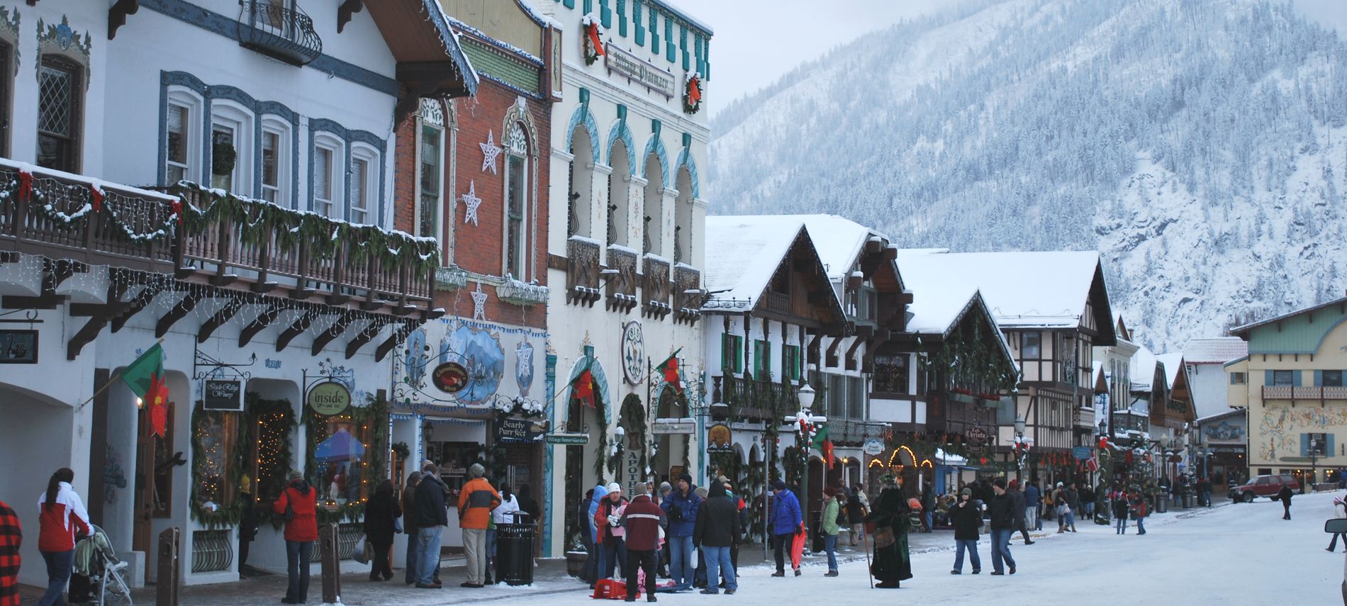 Exterior winter view of downtown Leavenworth showing white snow Christmas decorations.