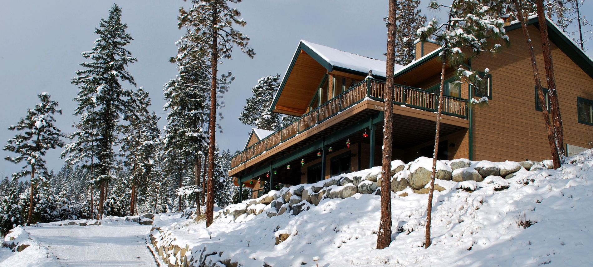 Exterior winter view of the Inn showing colorful Christmas decorations and white snow.