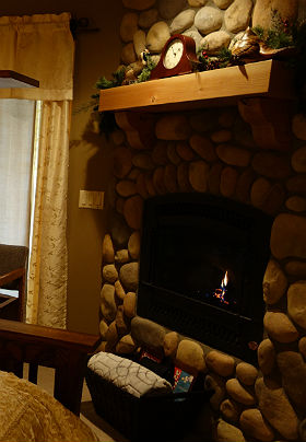 nterior of the room showing brown fireplace mantle and bird carvings.